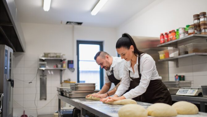 Chef and cook working on their dishes indoors in restaurant kitchen