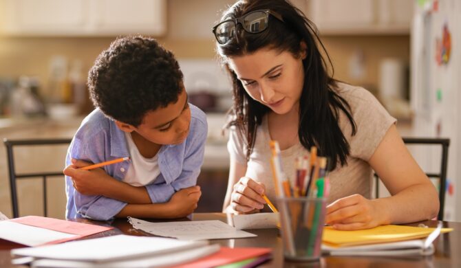 Woman Assisting Son In Doing Homework